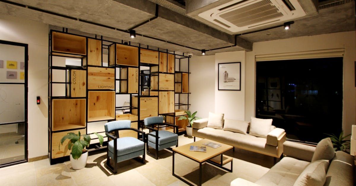 A living room with a couch , chairs , and a coffee table.