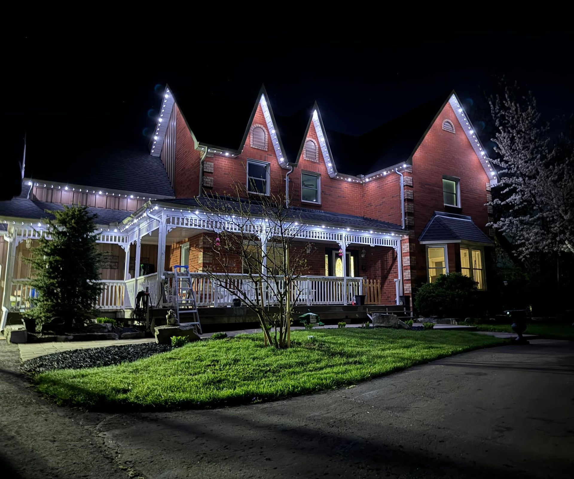Residential home with permanent white roofline lighting installed by Illumination Pros