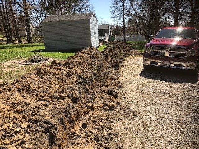 A Trench Beside Houses And A Car — Northfield, OH — Groppi Electric
