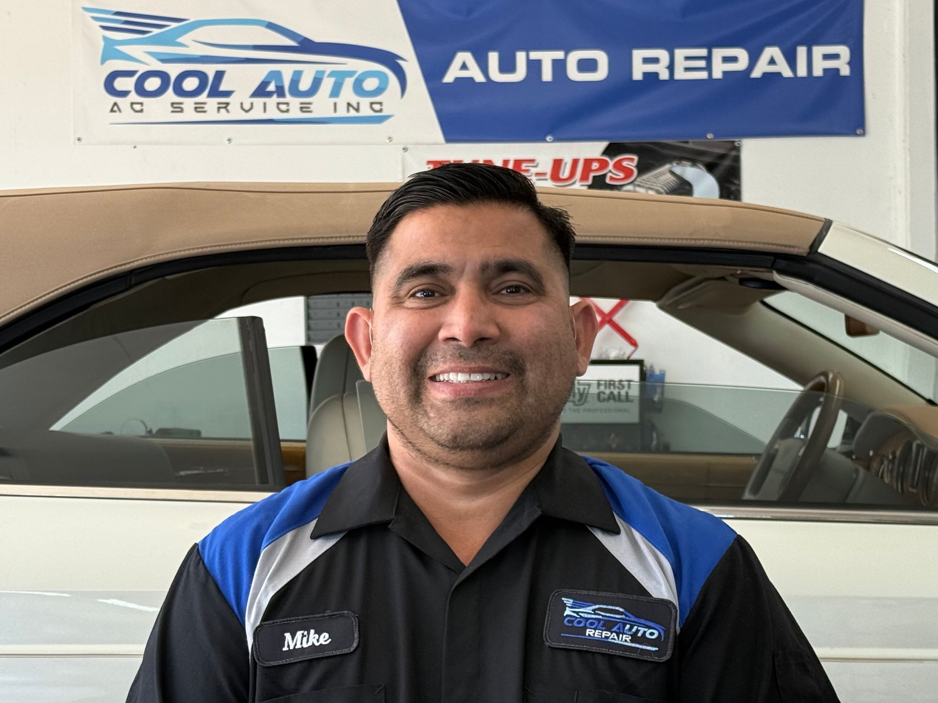 A man wearing a white shirt with the name mike on it