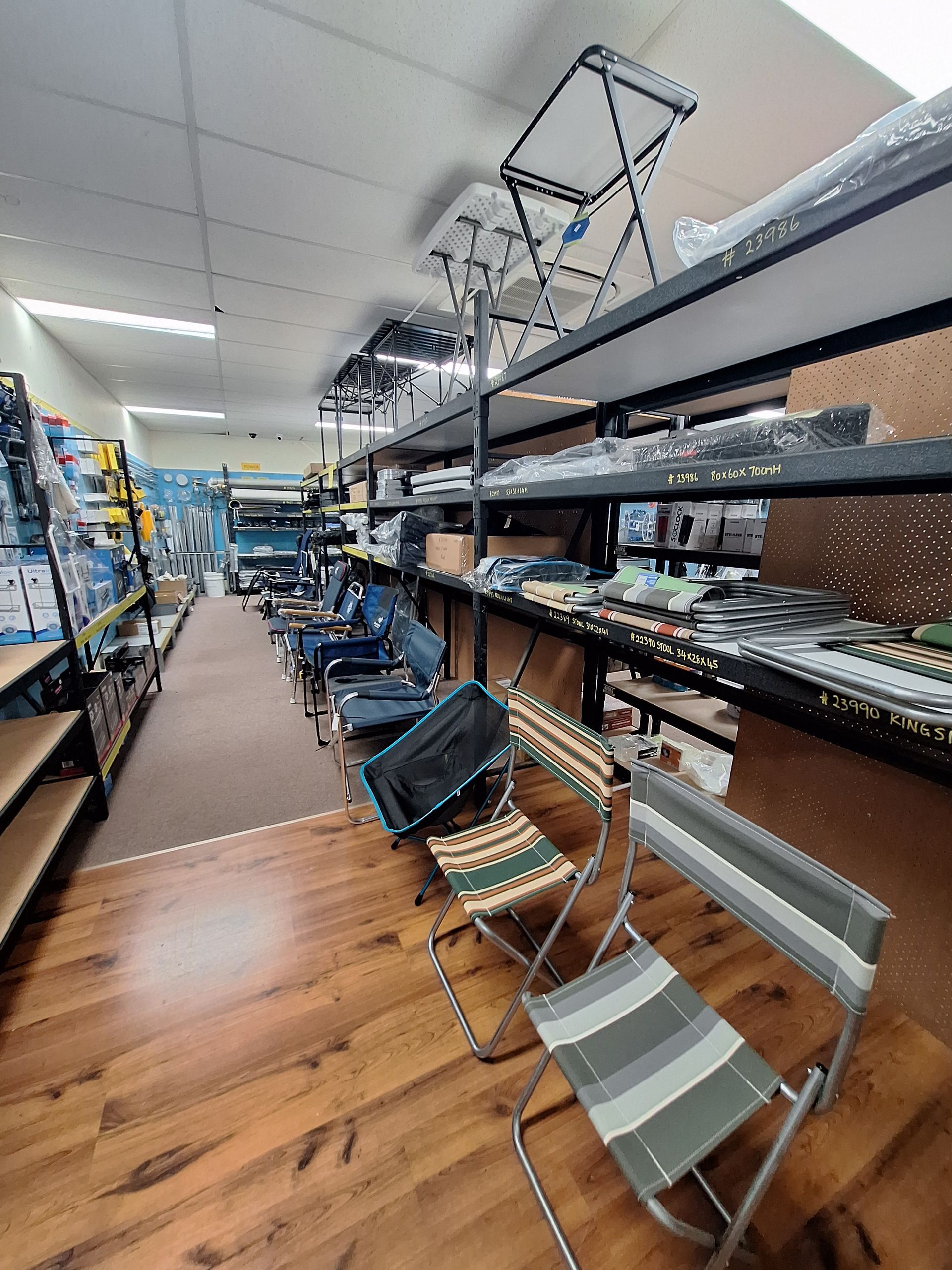 A store filled with lots of folding chairs on shelves — BTC Parts & Accessories In Pinelands, NT
