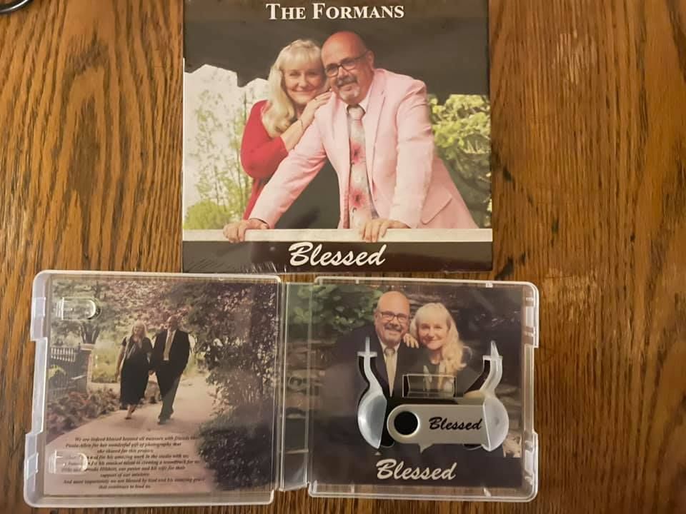 Album cover and CD case featuring a smiling couple,