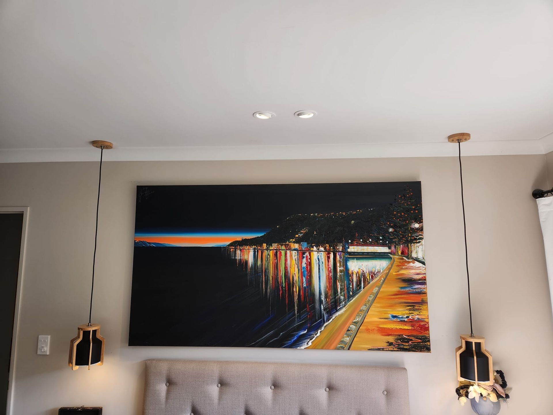 A bathroom with a toilet , sink and mirror.