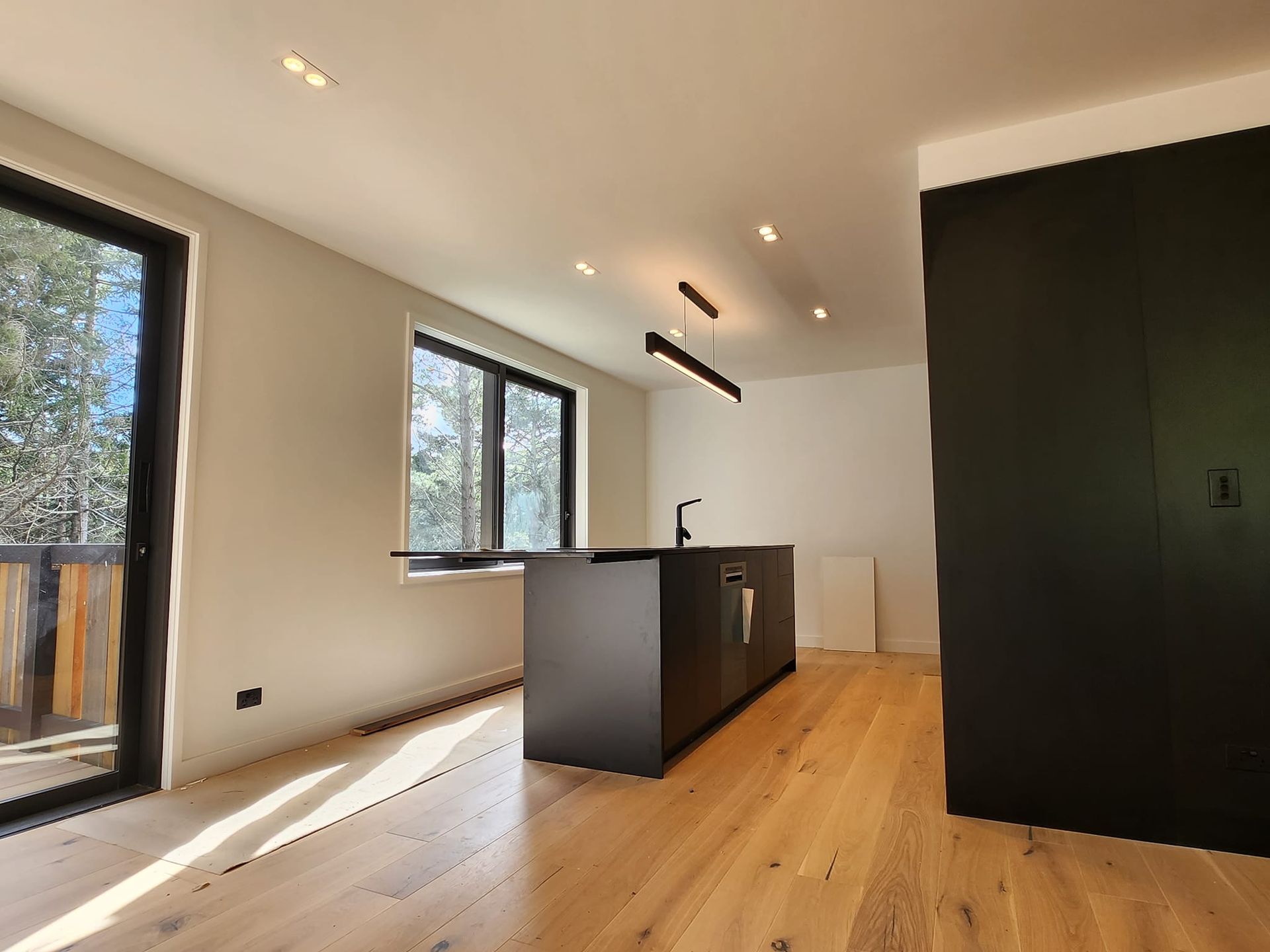 A kitchen with a large island and sliding glass doors
