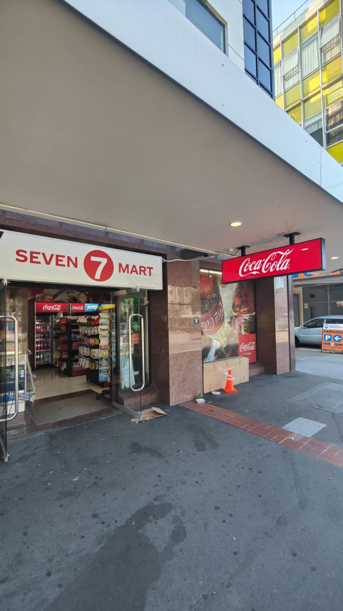 A store called seven 7 mart is located on the side of a building.