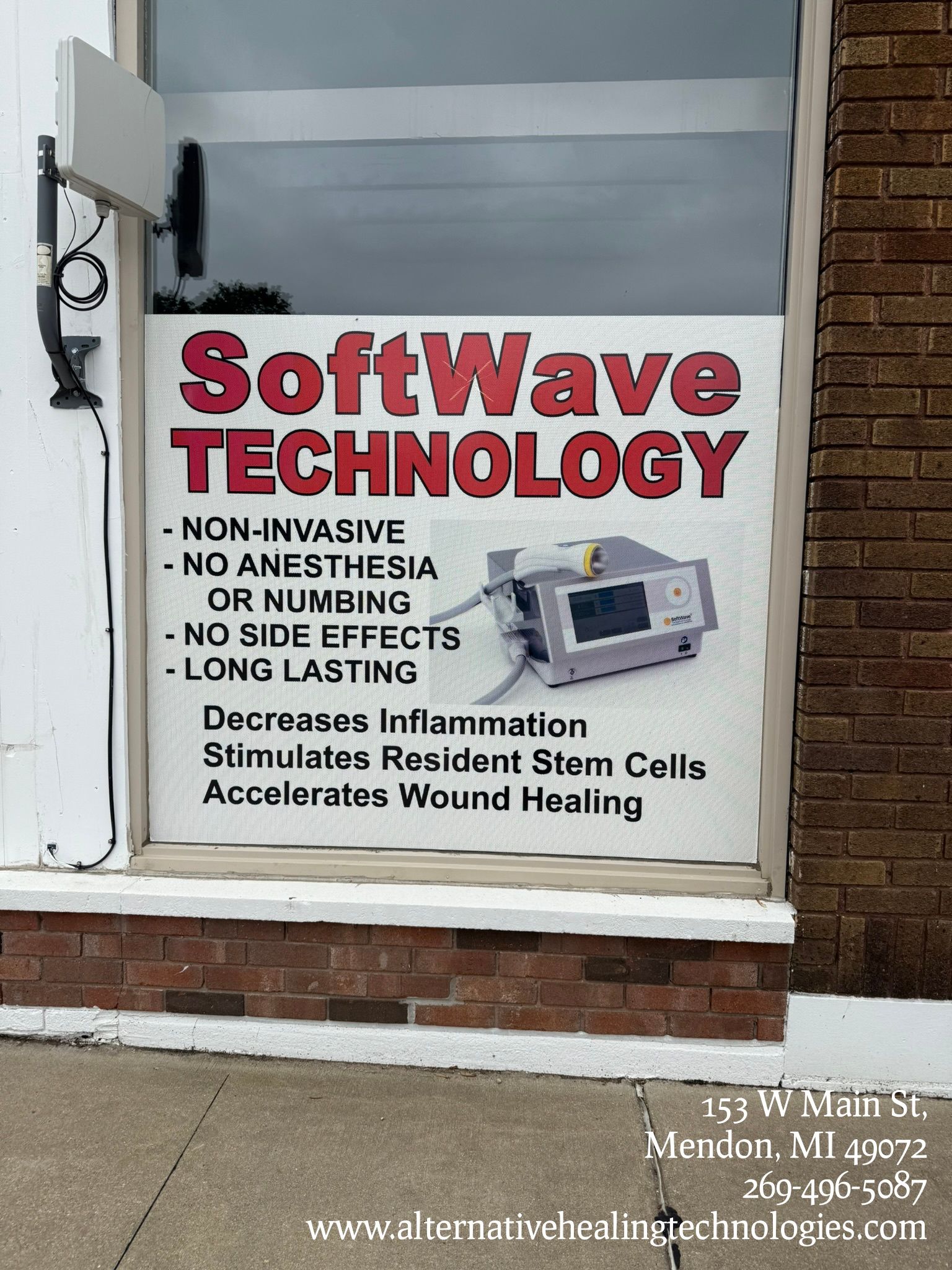 Medical room with equipment, anatomical chart, chair, and trash can.