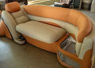 Orange-and-beige upholstered sofa with curved arms in a living room