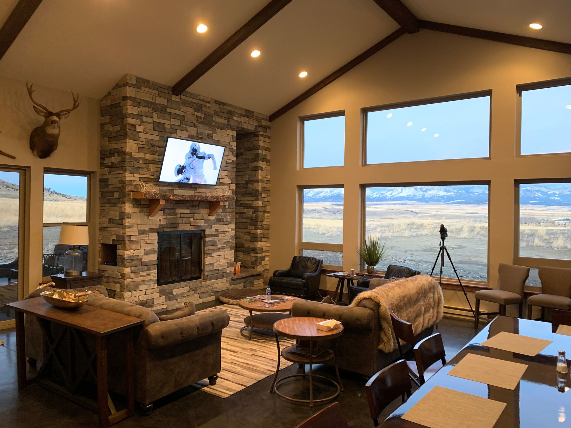 A living room with a fireplace and a television on the wall