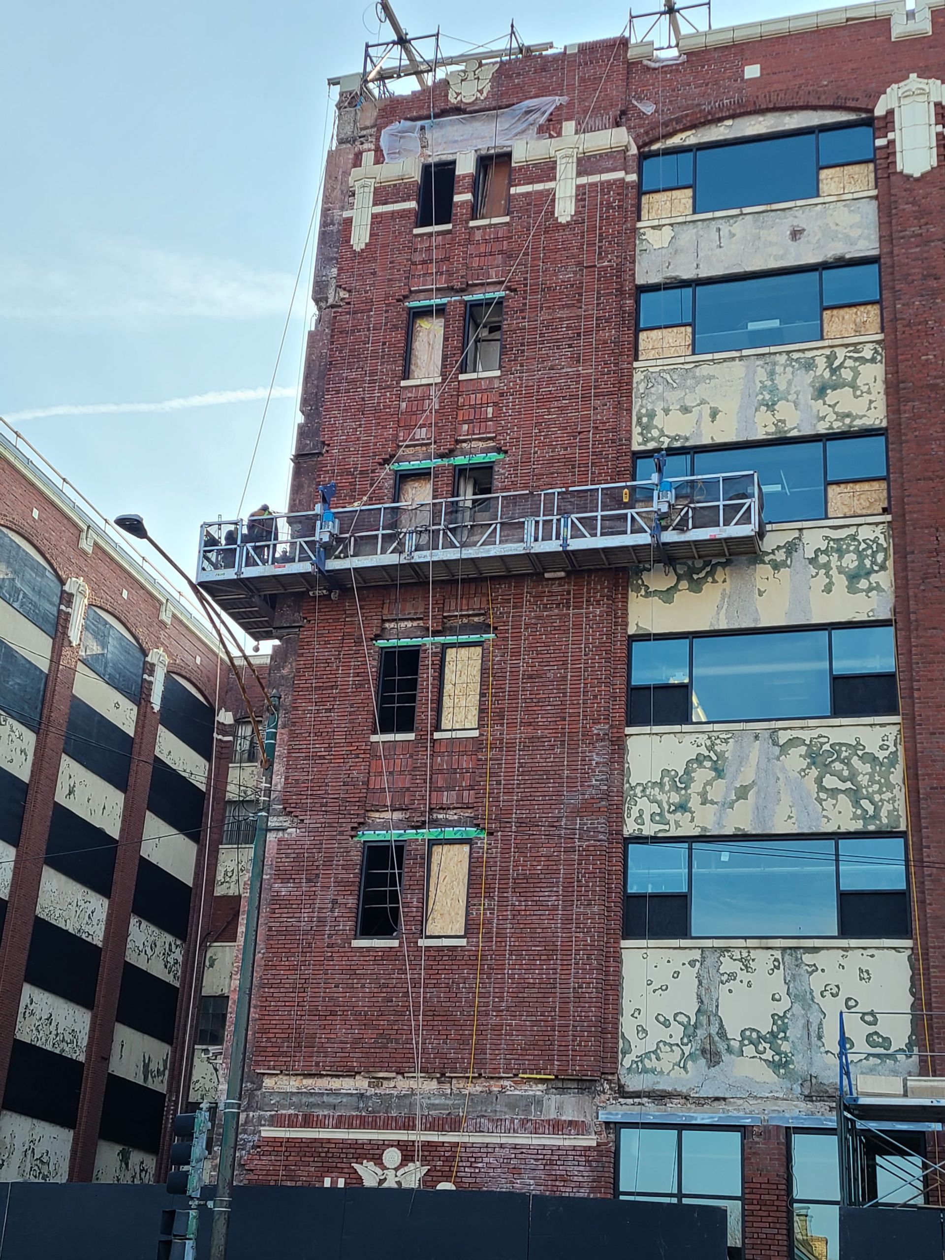A brick building with a lot of windows is being demolished
