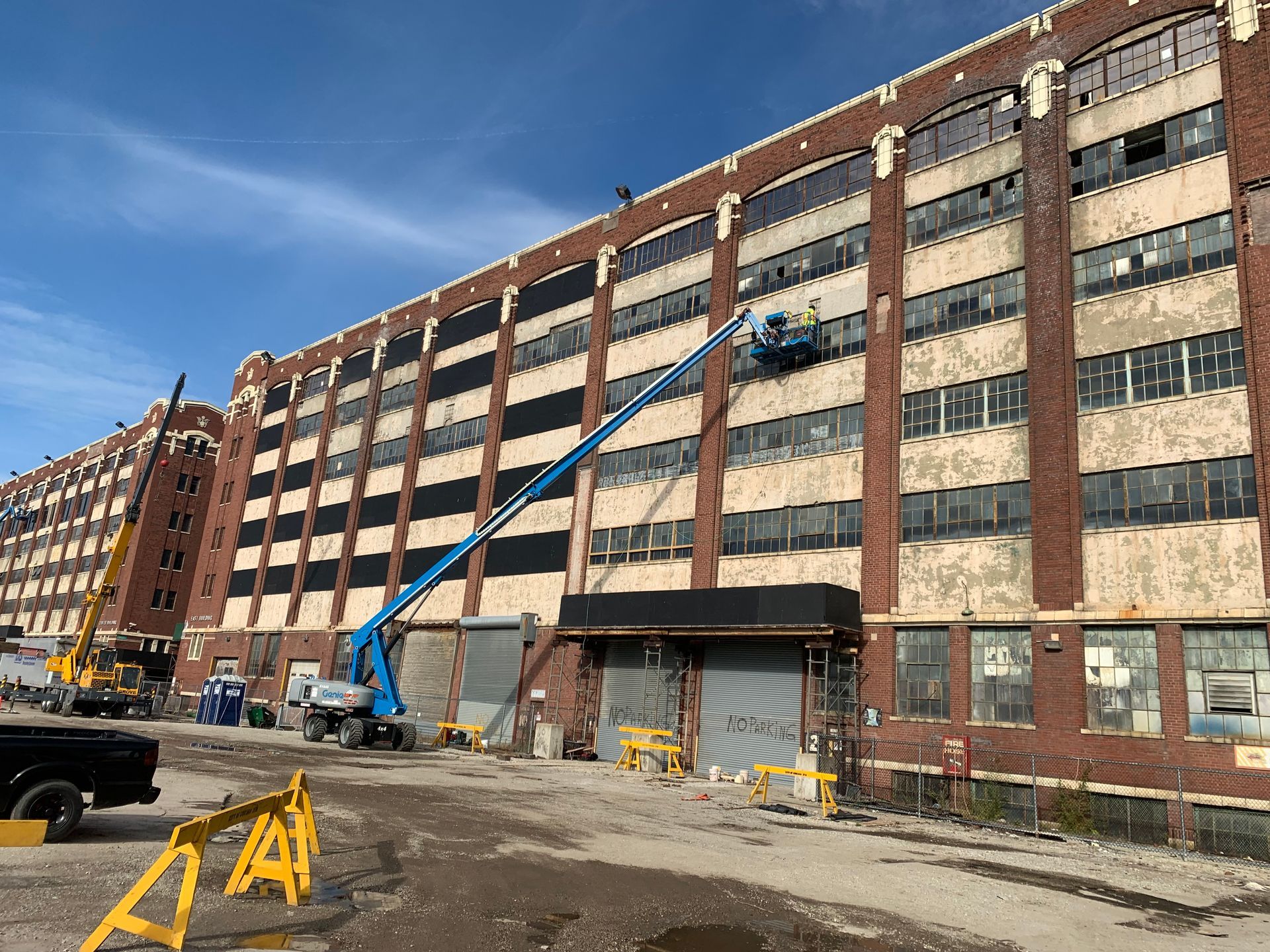 A large brick building with a crane on the side of it.