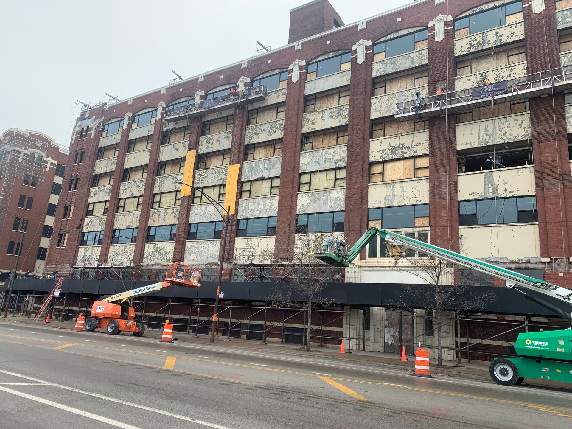 A large brick building with a lot of windows is being demolished