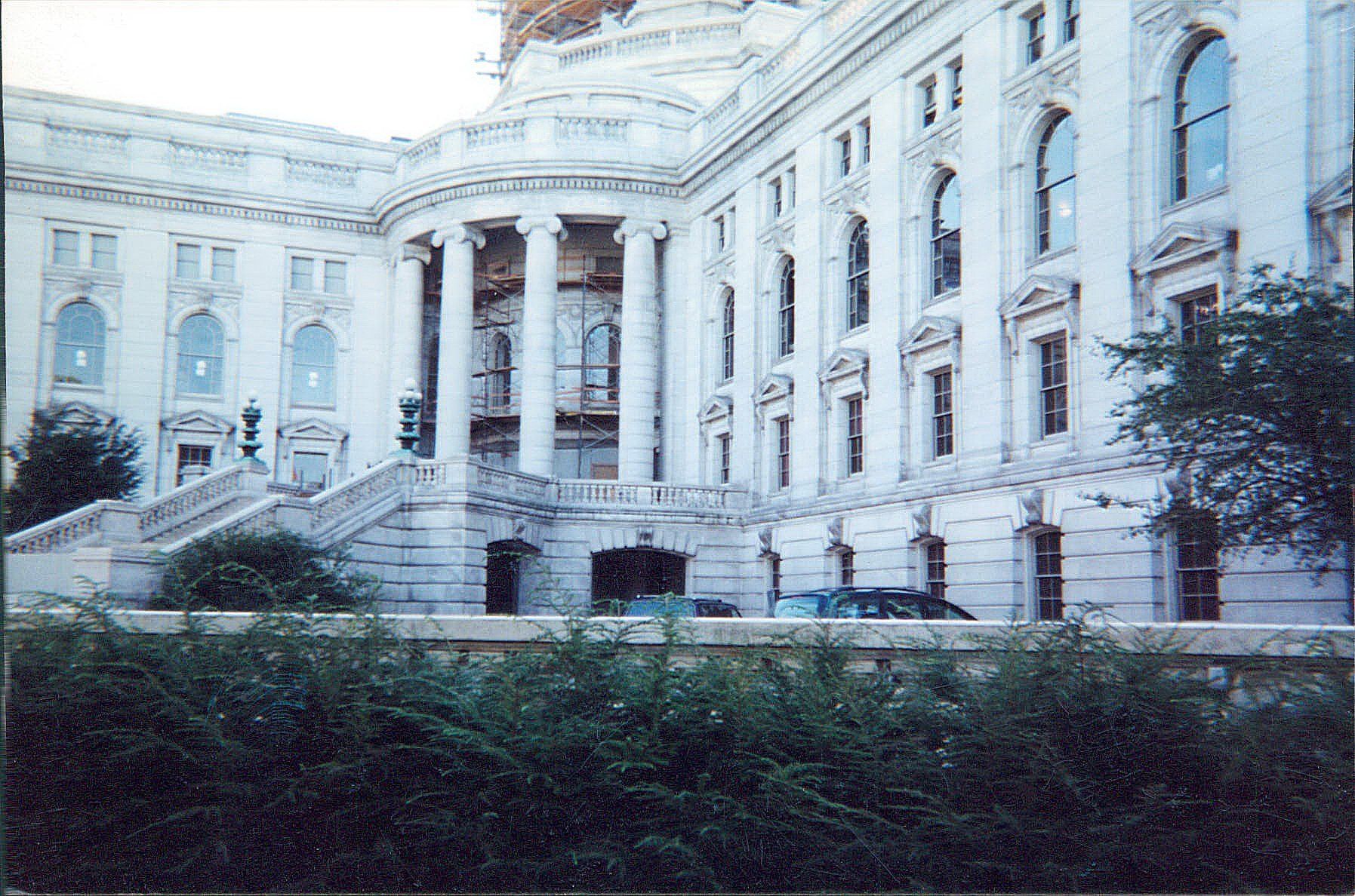 A large white building with columns and stairs