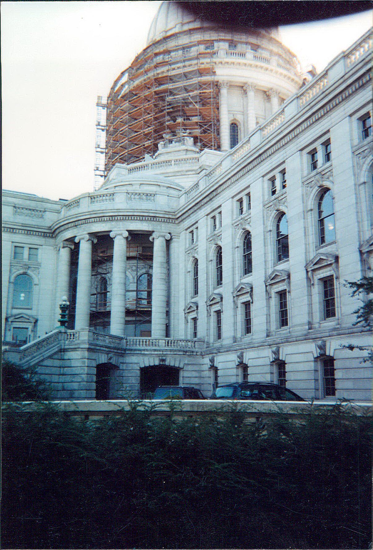 The capitol building is under construction with scaffolding around the dome