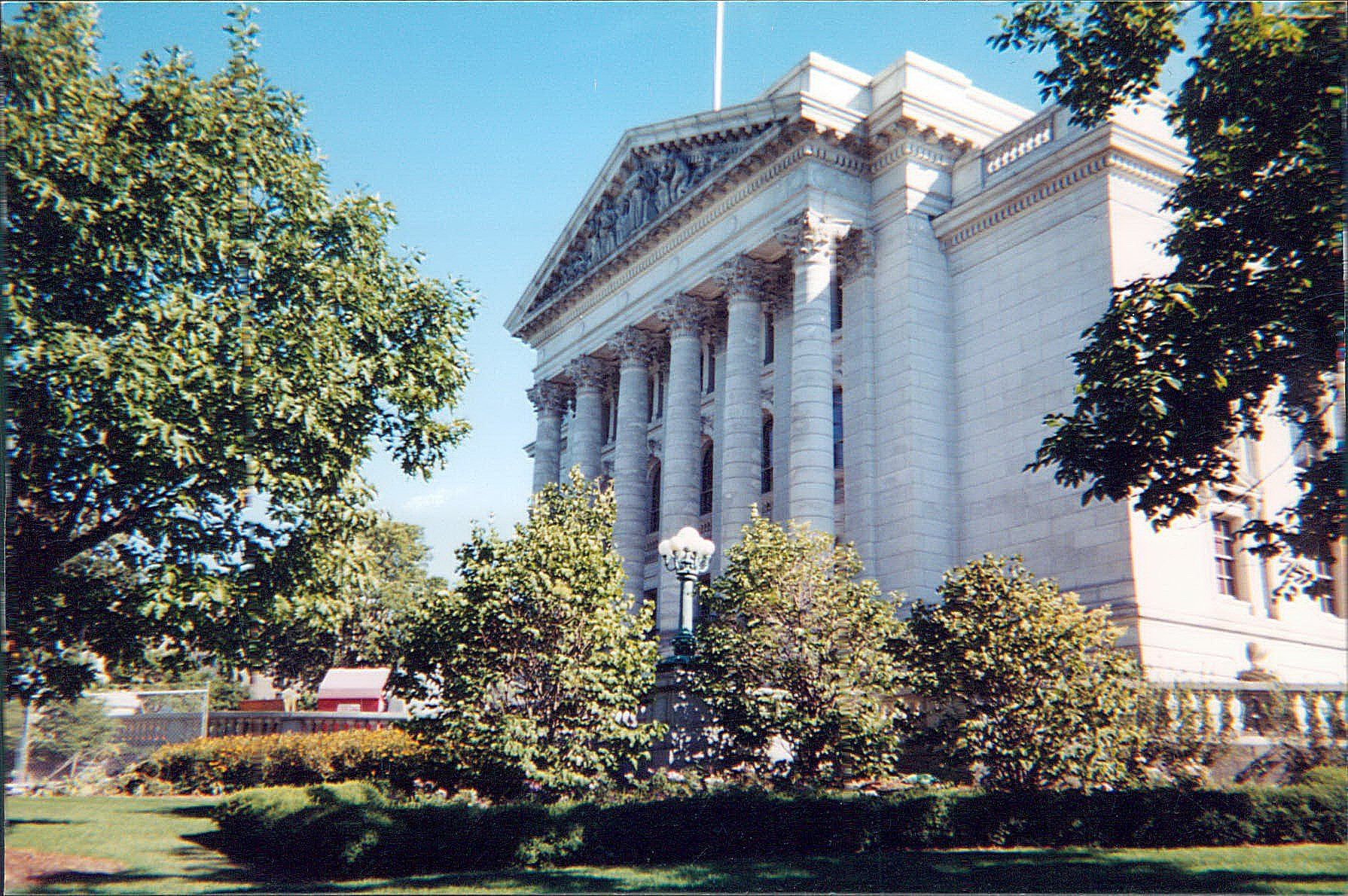 A large white building with trees in front of it