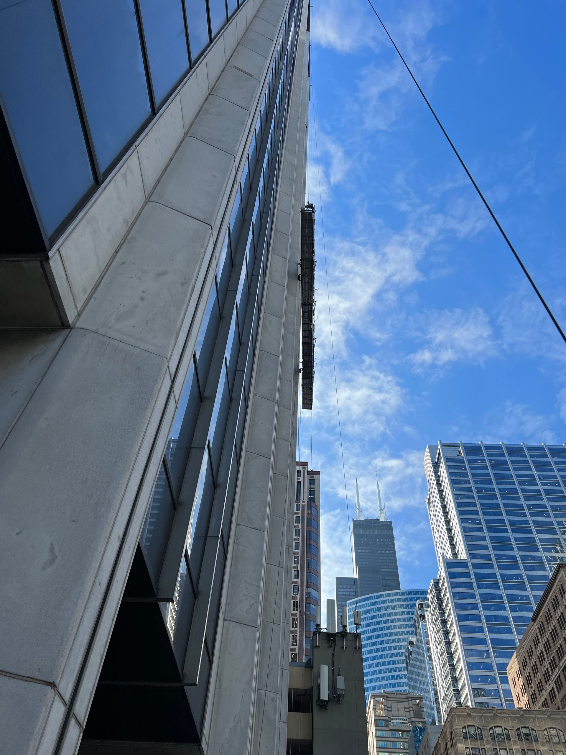 Looking up at a tall building with a blue sky in the background