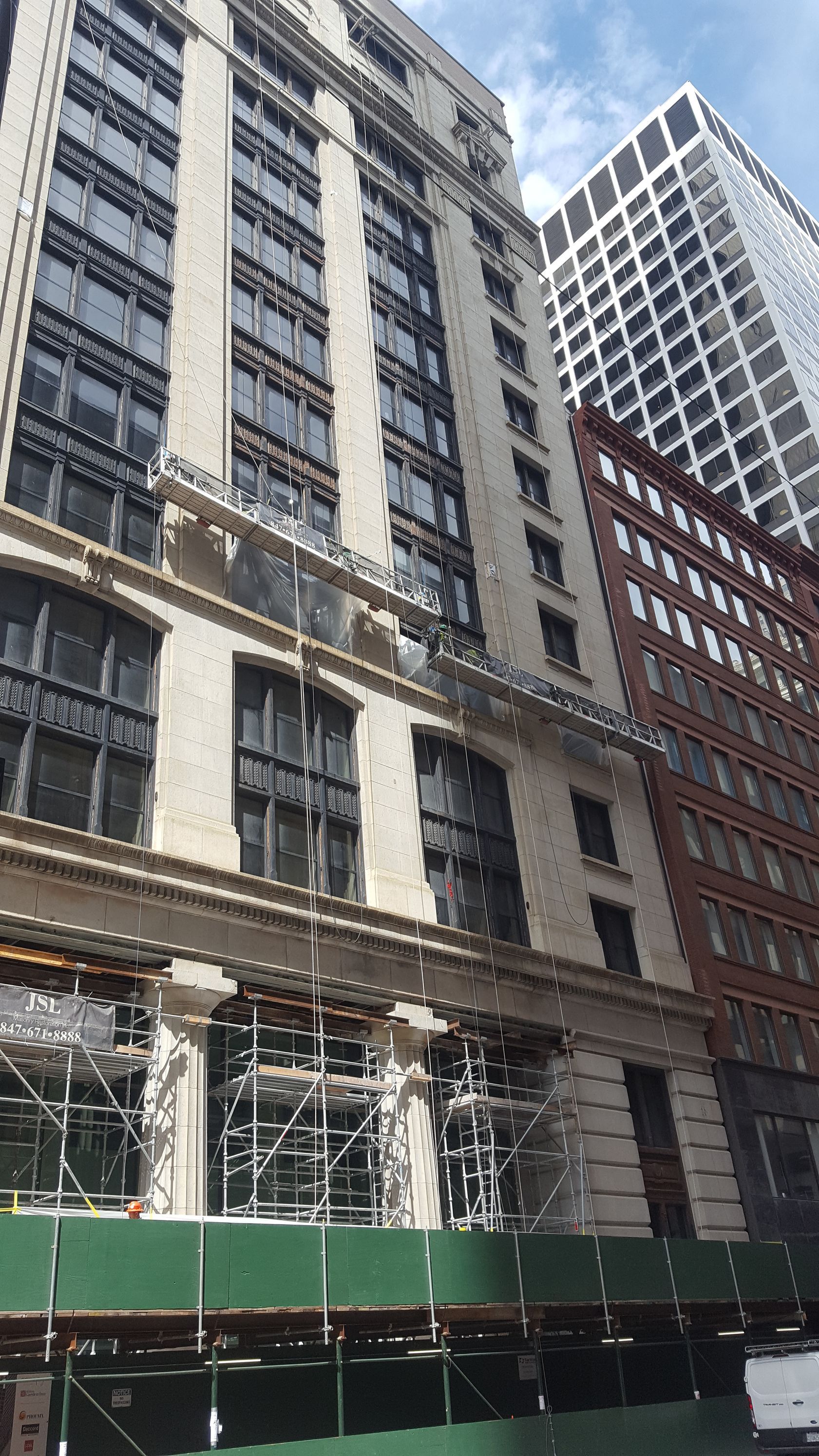 A large building with a lot of windows is under construction.