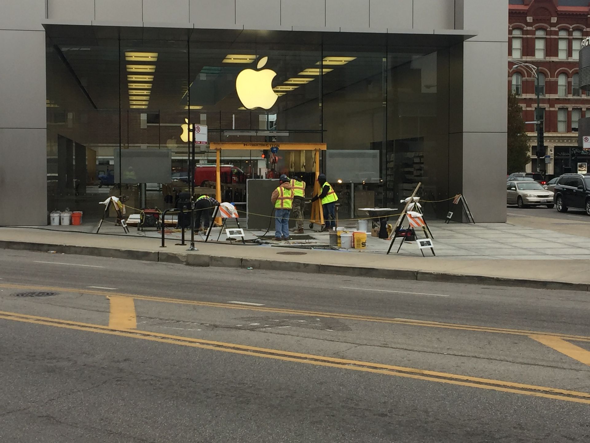 A group of people are working outside of an apple store