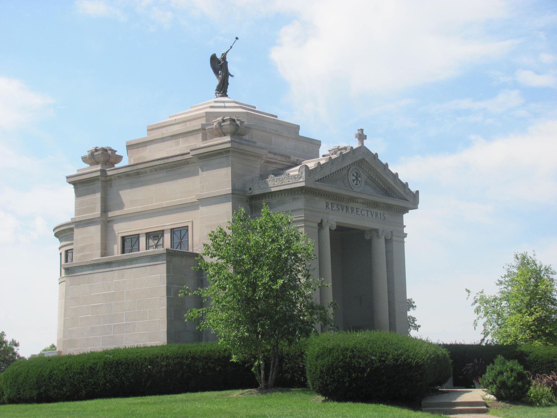 A large building with a statue of an angel on top of it