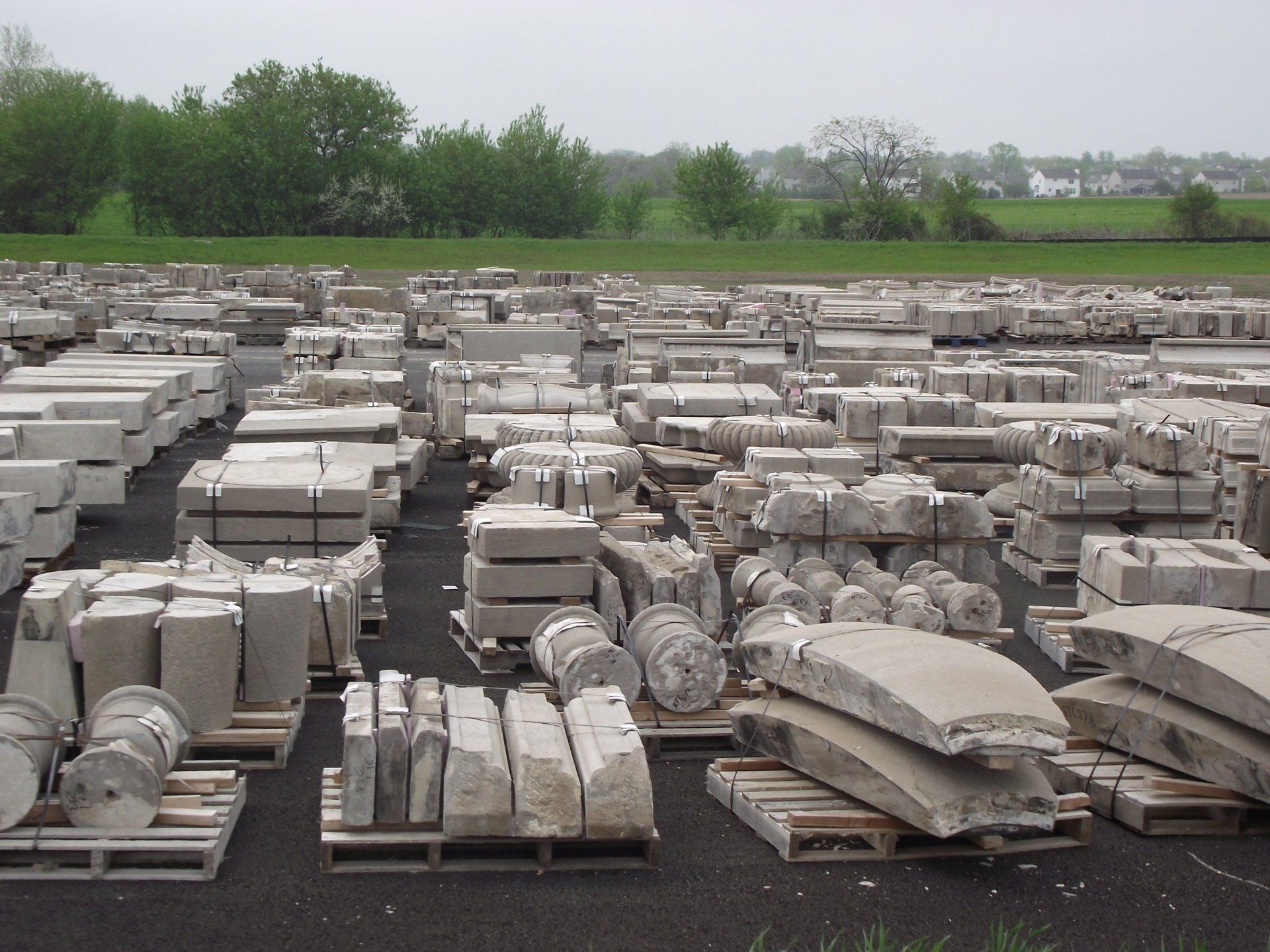 A warehouse filled with lots of concrete and wooden pallets