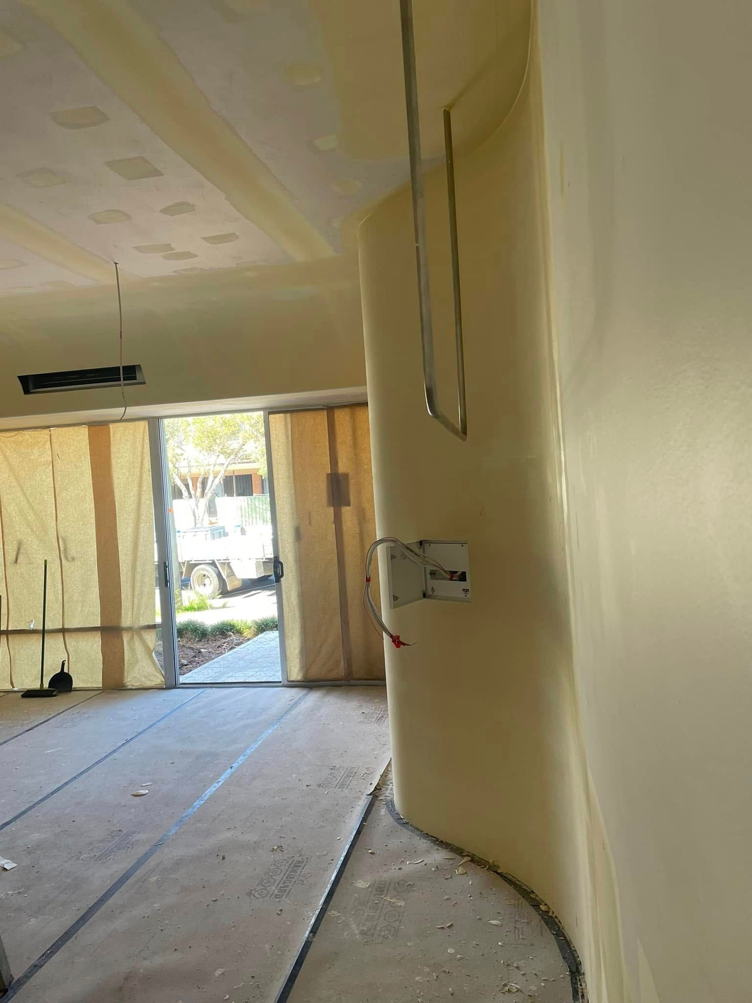 An Interior Construction Site Showing A Curved Wall And A Doorway — HJK Plastering In South Lismore, NSW