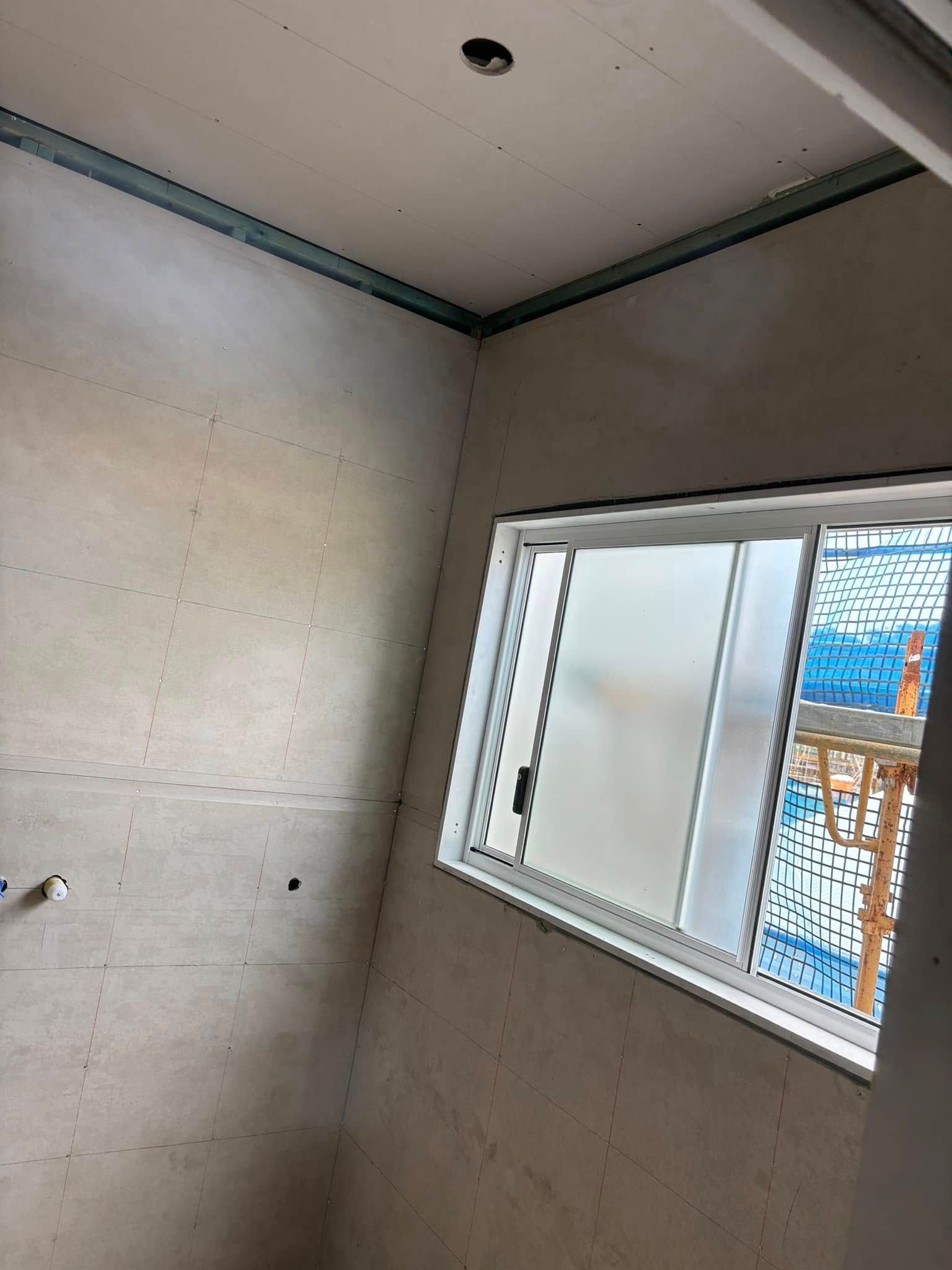 Unfinished Room Under Construction Featuring Drywall Panels And Window — HJK Plastering In South Lismore, NSW
