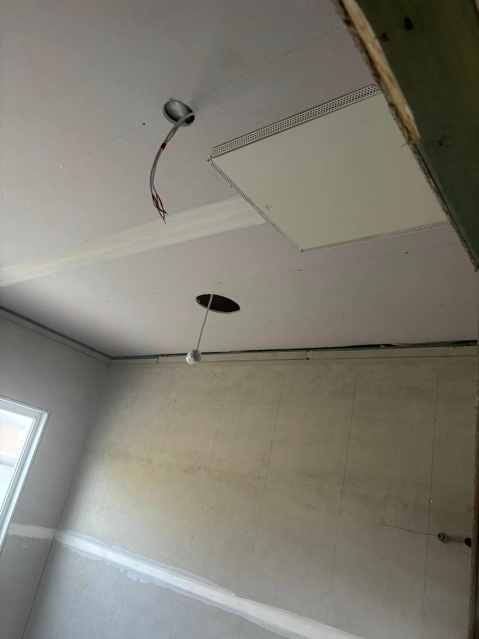 A Room With Exposed Electrical Wiring And A Ceiling Access Panel — HJK Plastering In Mullumbimby, NSW