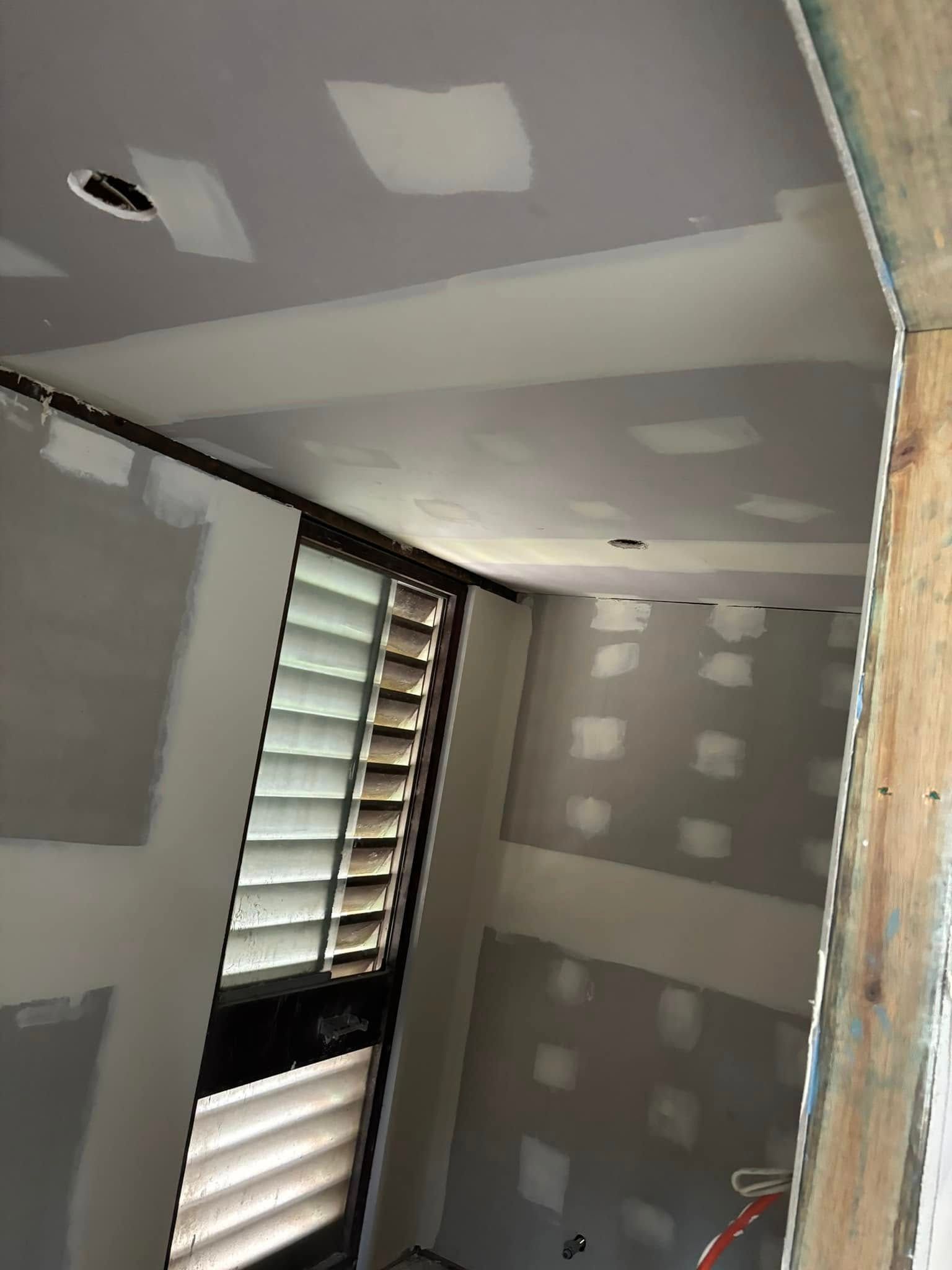 Unfinished Interior Room With Taped Drywall On The Ceiling And Walls — HJK Plastering In Lennox Head, NSW