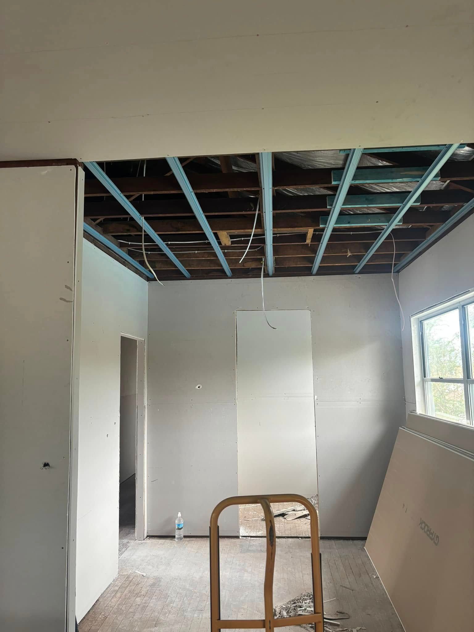 An Interior Room Under Renovation With Exposed Ceiling Beams — HJK Plastering In South Lismore, NSW