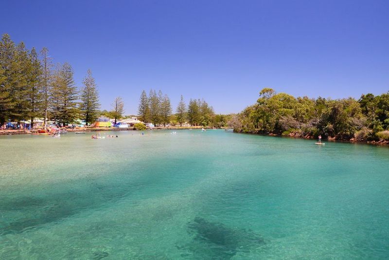 A Large Body of Water Surrounded by Trees on a Sunny Day — HJK Plastering In Ballina, NSW