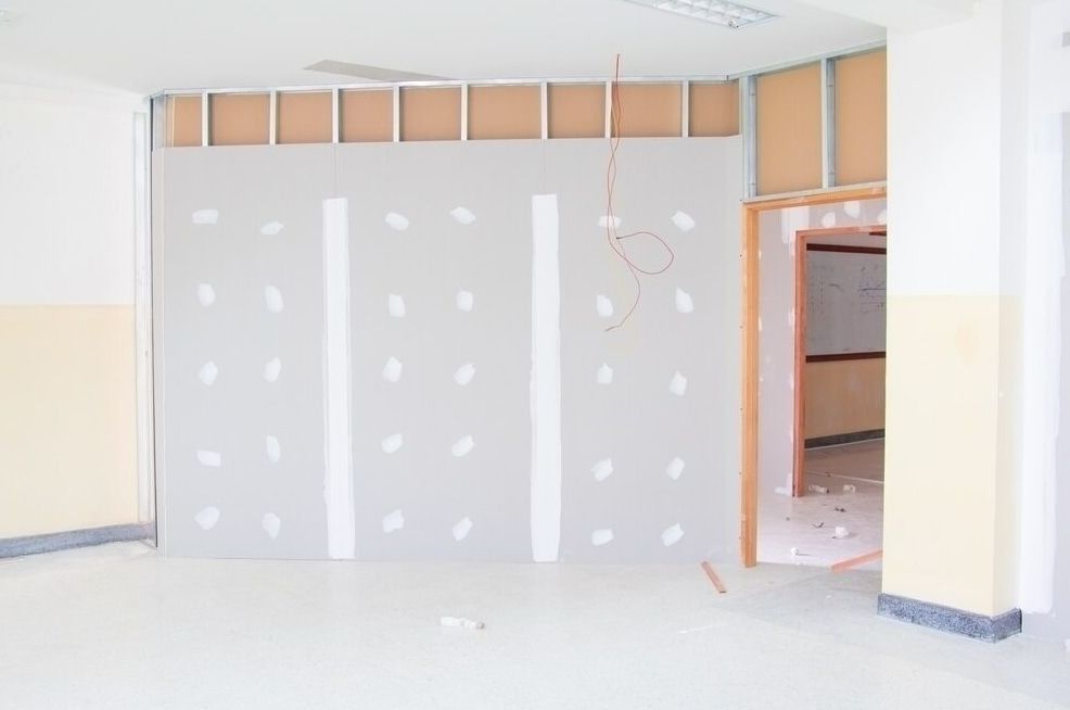 A Room Interior Showing A Half-finished Drywall Partition And Exposed Metal Framing — HJK Plastering In Mullumbimby, NSW