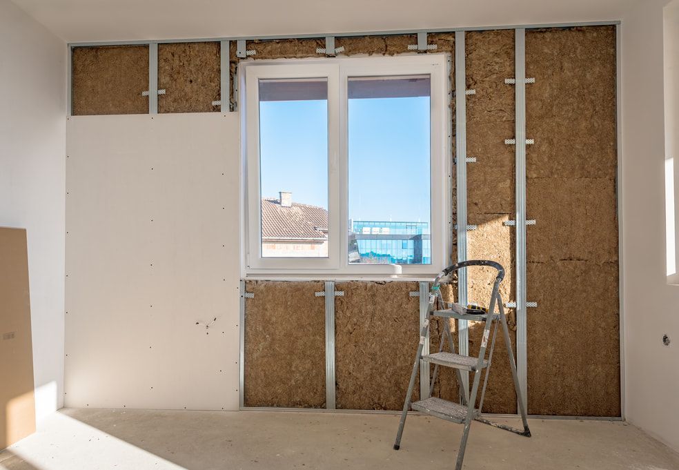 A Room Under Renovation Featuring A Metal-framed Wall With Insulation Panels — HJK Plastering In Mullumbimby, NSW