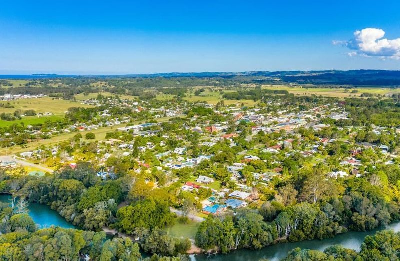 An Aerial View of a Small Town Surrounded by Trees and a River — HJK Plastering In Mullumbimby, NSW