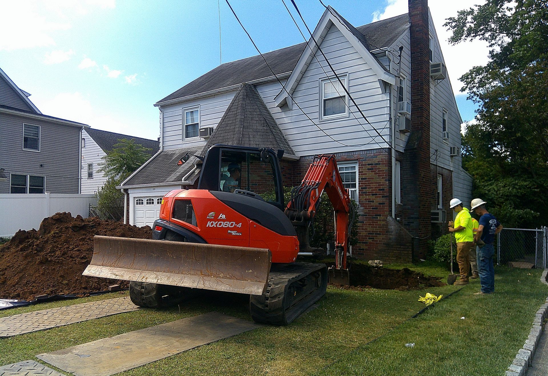 A bulldozer is parked in front of a house