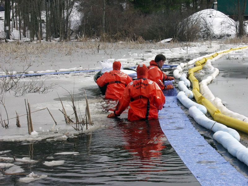 A group of people are standing in a body of water