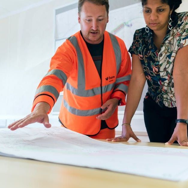 A man and a woman are looking at a piece of paper