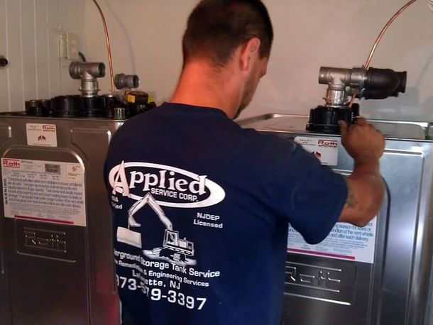 A man wearing a blue shirt with the word applied on it