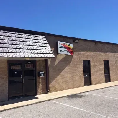 A brick building with a sign that says prestige on it