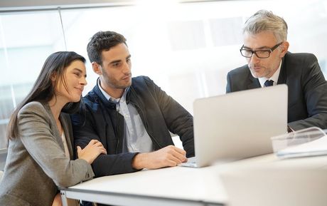 three people looking at the laptop