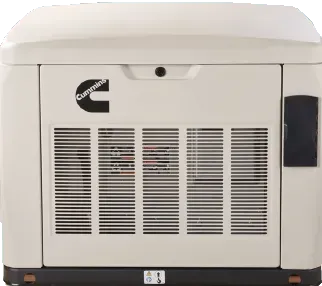 A generator is sitting in the grass in front of a house.