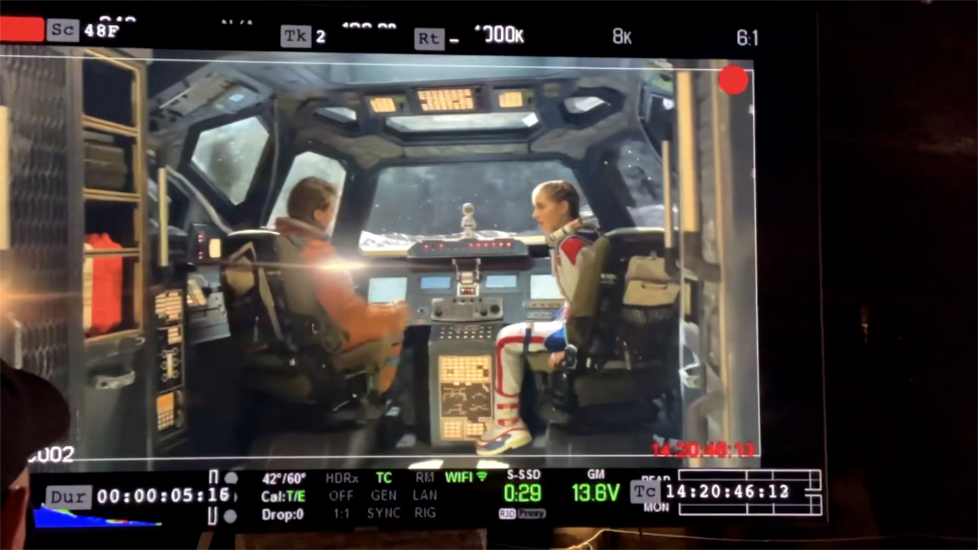 A man and a woman are sitting in the cockpit of an airplane.