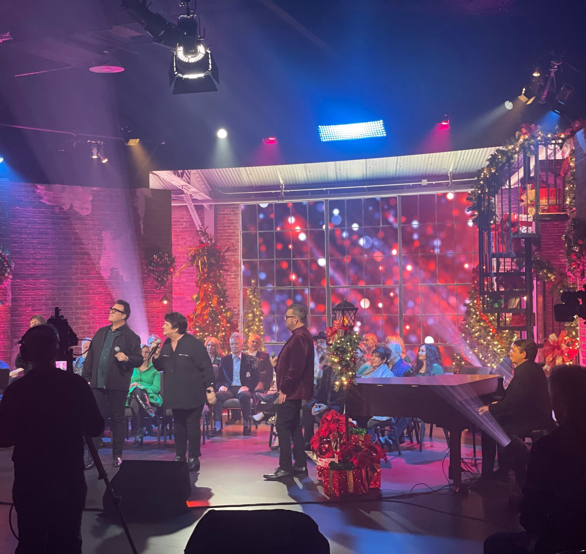 A group of people on a stage with christmas decorations