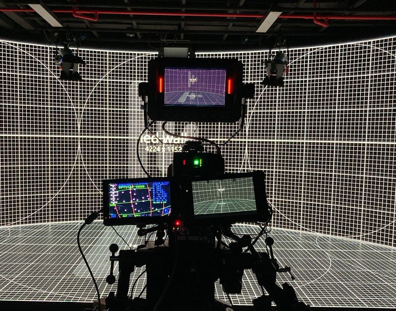 A camera is sitting in front of a screen with a pattern on it