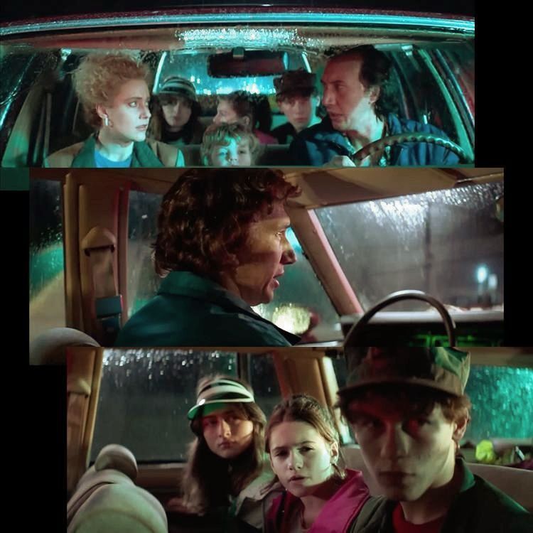 A group of people are sitting in a car at night