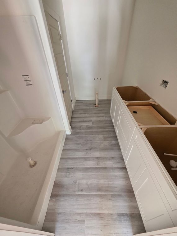 A bathroom with a bathtub , sink , and shower.