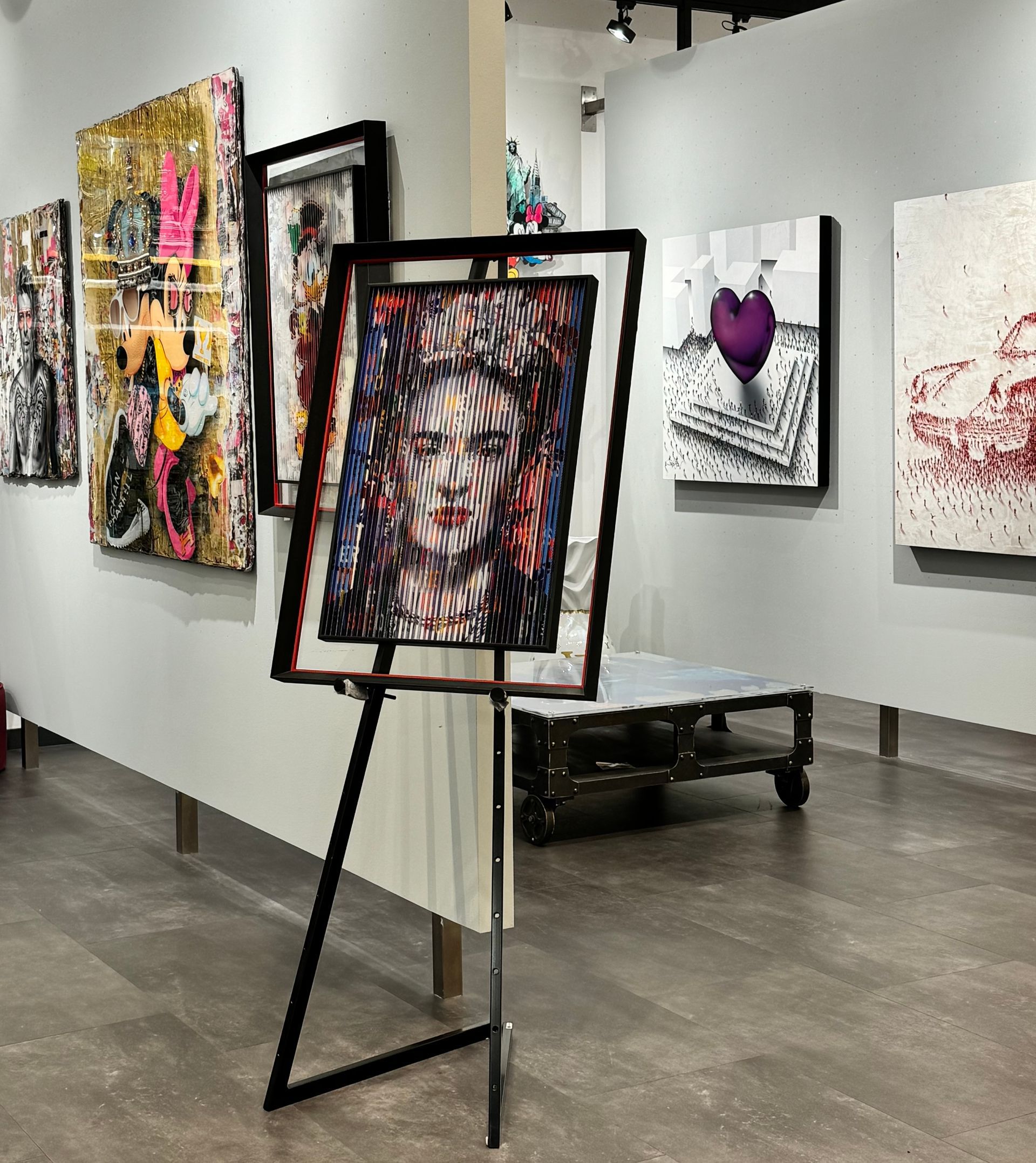 A painting is hanging on a wall in a museum