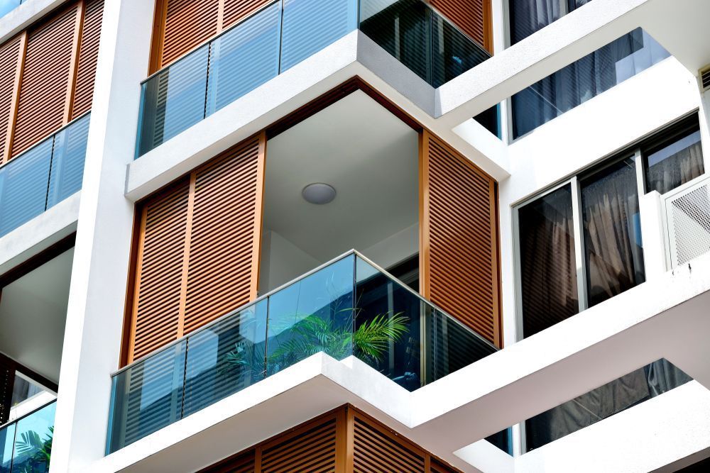 A Building With a Lot of Windows and Balconies — Whitsunday Architectural Windows & Doors in Proserpine, QLD