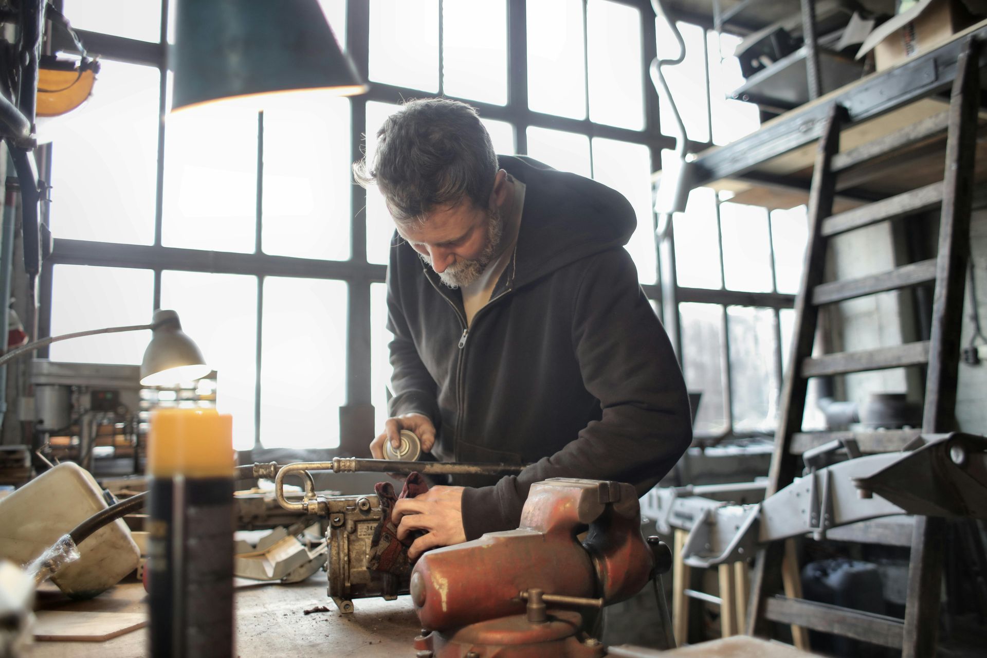 A man is working on a machine in a workshop.