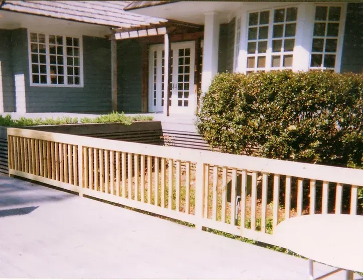 A house with a wooden fence in front of it
