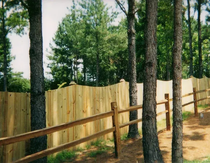 A wooden fence in the middle of a forest