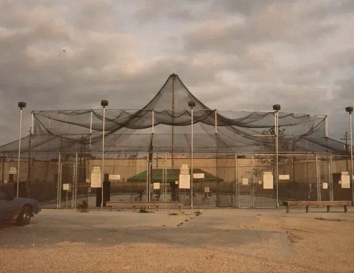 A fenced in area with a large net on top of it